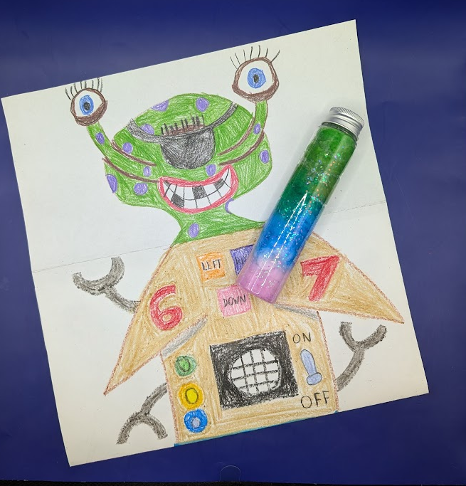 Alien drawing and glitter in a tube.