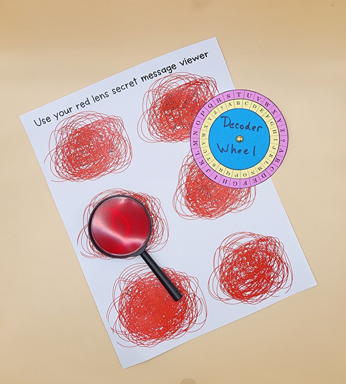 Secret code paper, decoder, and a magnifying glass.