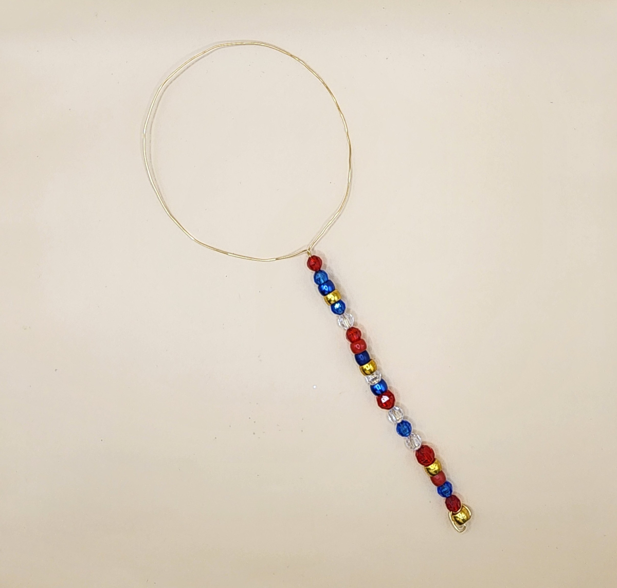 Bubble wand made with wire and beads.