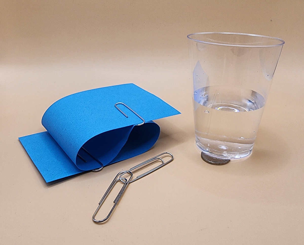 Paper, paperclip, and water in a cup.