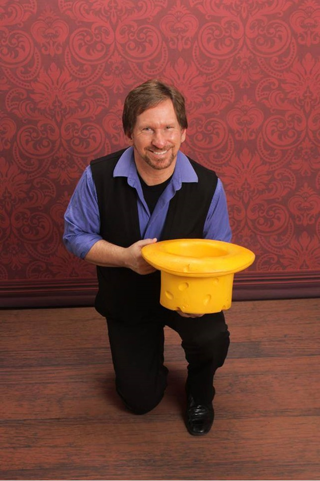 Man on his knee with a cheese hat.
